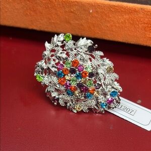 Silver and Green Gemstone Ring with Intricate Design